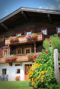 a house with flower boxes on the front of it at Ferienwohnungen Anderlbauer in Lofer