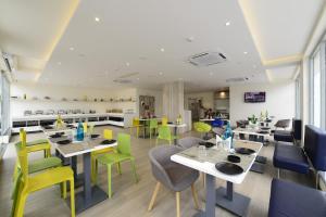 a restaurant with colorful chairs and tables in a cafeteria at Ginger Lucknow in Lucknow