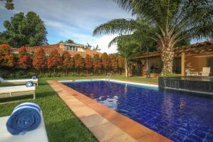 a swimming pool in the yard of a house at No.5 Boutique Hotel in Entebbe