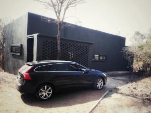 a black car parked in front of a black building at Ochre House in Marloth Park