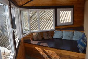a room with a couch in a cabin with windows at Apart-Hotel Parasolka in Chernihiv