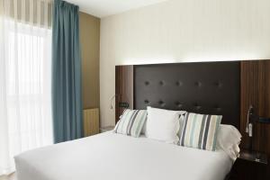 Кровать или кровати в номере Petit Palace Tamarises