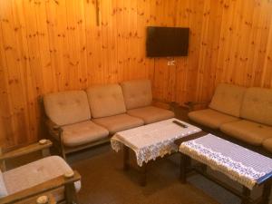 a living room with a couch and a table at B&B Haus Granit Saas Grund in Saas-Grund