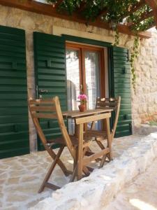 a wooden table and chairs on a patio at Dvori svetog Mihaela in Šibenik