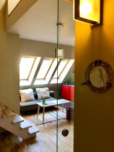 a living room with a couch and a skylight at Apartament Rolna CUBE27 in Poznań