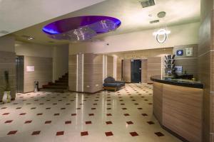 a lobby with a purple chandelier in a building at Hotel Akord - Free Parking & Metro Access in Sofia