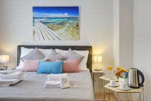 a bedroom with a bed with a view of the ocean at D&A Amphitheatre Apartments with free parking in Pula