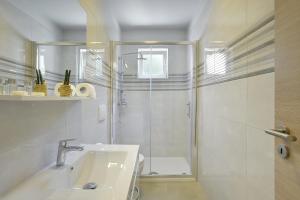 a bathroom with a shower and a sink at D&A City Center Apartments with free parking in Pula +37 photos