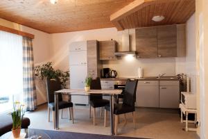a kitchen and dining room with a table and chairs at Ferienwohnungen Hasenpatt in Bad Sachsa
