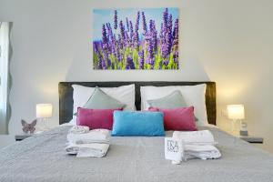 a bedroom with a bed with towels on it at D&A Amphitheatre Apartments with free parking in Pula