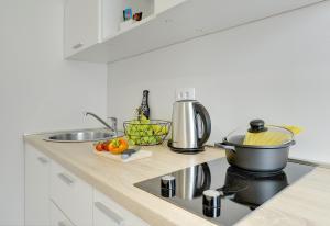 a kitchen counter with a pot on a stove at D&A Amphitheatre Apartments with free parking in Pula