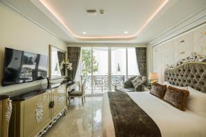 a bedroom with a large bed and a balcony at LK Emerald Beach - SHA Extra Plus in Pattaya North