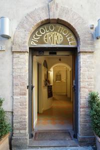 an entrance to a restaurant with a sign over the door at Piccolo Hotel Etruria in Siena