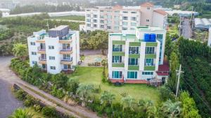 an aerial view of a building with palm trees at Jeju Bada Wi Olle Pension in Seogwipo