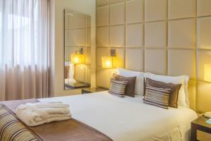Cama ou camas em um quarto em Your Hotel & Spa Alcobaça