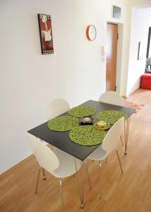 a dining room table with chairs and a pond on it at Apartment Sarajka Center in Sarajevo