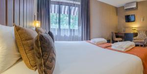 Cama ou camas em um quarto em Your Hotel & Spa Alcobaça