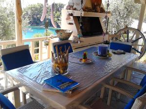 a wooden table on a patio with at Odyssia near the Seaside in Aghios Petros Alonissos