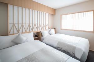 Postel nebo postele na pokoji v ubytování Tomoya Residence Hotel Kyoto