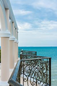 a balcony with a view of the ocean at LK Emerald Beach - SHA Extra Plus in Pattaya North