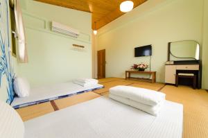 Postel nebo postele na pokoji v ubytování 雲庭民宿 Yunting B&B