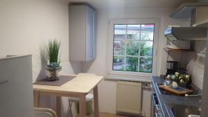 a small kitchen with a table and a window at FeWo in Wismar in Wismar