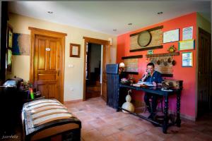 a man sitting at a desk in a room at El Búho de la Remolina in Bode +45 photos