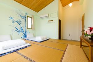 Postel nebo postele na pokoji v ubytování 雲庭民宿 Yunting B&B