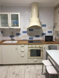 a kitchen with a sink and a stove at pensionsanpelayo10 in Cangas de Onís