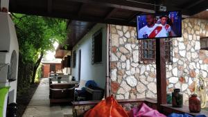 a tv on the side of a stone house at Bohemian Spirit, Vama Veche in Vama Veche