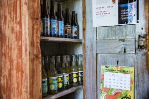a shelf with bottles of beer and a calendar at Puukarin Pysäkki in Valtimo