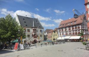 a group of buildings in a town square with bikes at Ferienwohnung Weinklang in Volkach