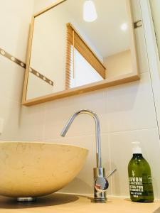 a bathroom with a sink and a mirror at La Belle Verte in Pornic