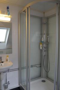 a shower with a glass door in a bathroom at Lunheim in Geiranger in Geiranger