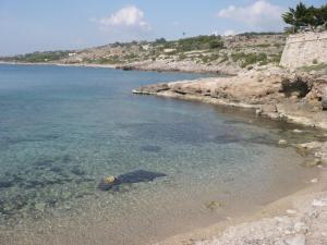 a body of water with a rocky shoreline at B&B Yatabui in Patù