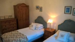 a bedroom with two beds and a dresser at 'La Maison Catalpa' French Farmhouse with Pool & Jaccuzi in Saint-Privat-des-Prés +46 photos