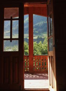 eine offene Tür mit Blick auf einen Balkon in der Unterkunft Hostel SvanLand in Mestia