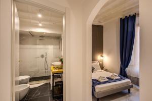 a bathroom with a bed and a sink and a toilet at Little Queen Pantheon in Rome +39 photos