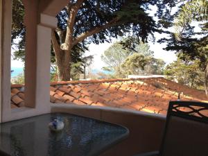a table on a porch with a view of a roof at Les Artistes Inn in San Diego