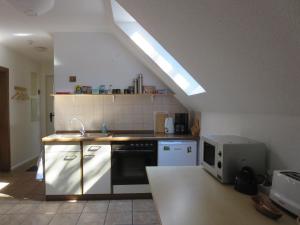a kitchen with a sink and a counter with a microwave at Natururlaub Frankenau in Frankenau +21 photos