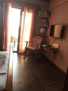 a room with a chair and a desk with a television at Apartment Klara in Bar