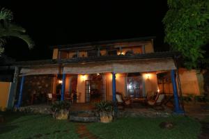 a house at night with lights on the porch at Villa Kusum in Hikkaduwa
