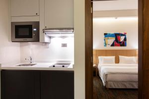 Ένα ή περισσότερα κρεβάτια σε δωμάτιο στο Citea Apart Hotel