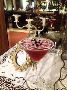 un cóctel en una copa sobre una mesa con un espejo en Hotel Gioiella Depandance, en Bellaria-Igea Marina