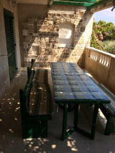 einen Picknicktisch und zwei Stühle auf einer Terrasse in der Unterkunft Apartments Radić in Bol