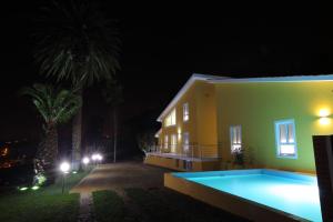 a villa with a swimming pool at night at Up Quinta dos Meireles in Albergaria-a-Velha