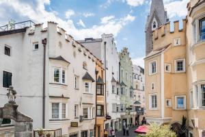 a city street with buildings and a church at Apartment Valentina in Bressanone