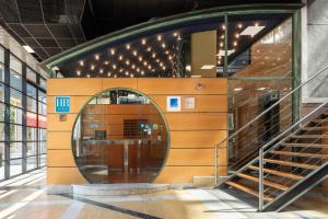 a spiral staircase in a building with a round doorway at Exe Area Central in Santiago de Compostela