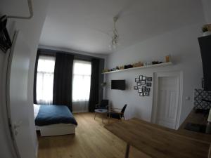 a bedroom with a bed and a chair in a room at Atelier Foto Lipowa - Apartamenty in Nałęczów