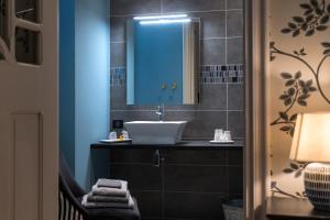 a bathroom with a sink and a mirror at Le Relais in Bagnères-de-Bigorre +32 photos